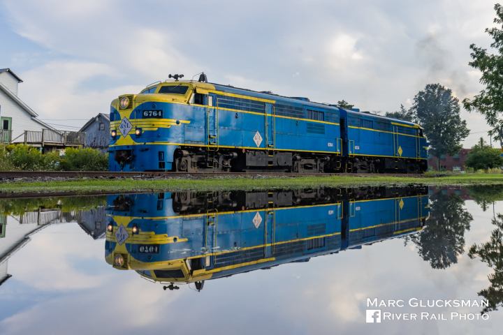 a blue train on a steel track