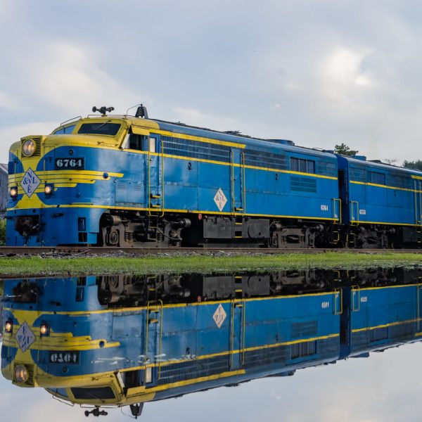 a blue train on a steel track