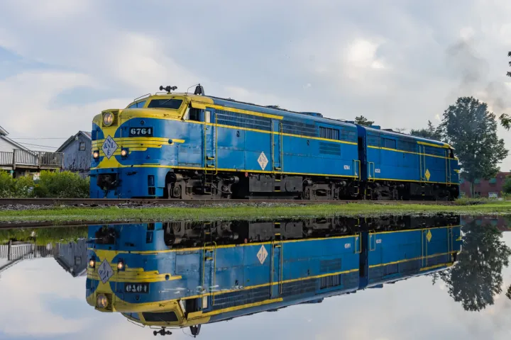 a blue train on a steel track