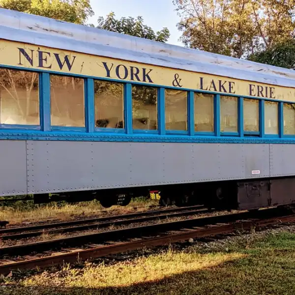 a large long train on a track with graffiti on the side