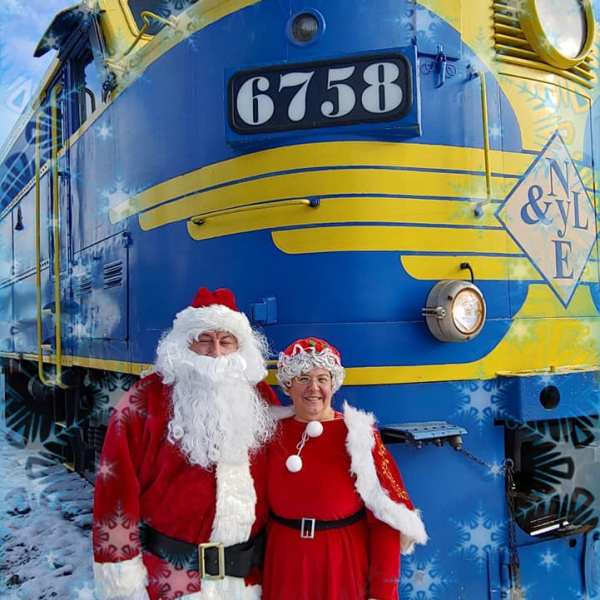 a person standing next to a train